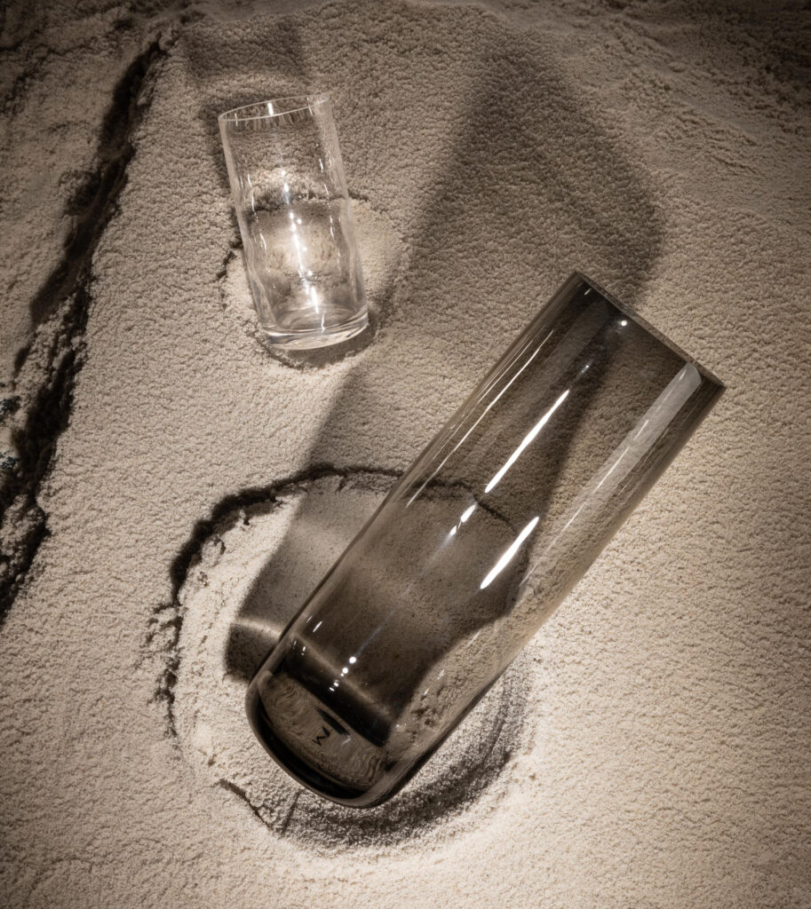 Dunes carafe and glass in the sand